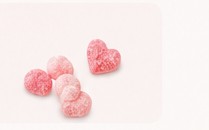 Pink heart shaped sweets on a soft blush background